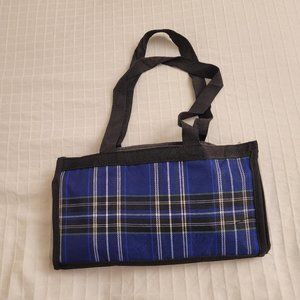 Blue plaid collapsible wheeled travel bag with small makeup bag.